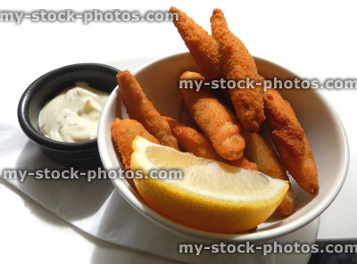Stock image of deep fried whitebait fish in golden breadcrumbs, lemon, mayonnaise