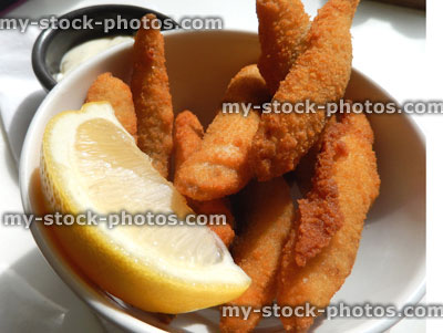 Stock image of deep fried whitebait fish in golden breadcrumbs, lemon, mayonnaise