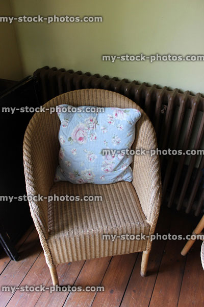 Stock image of hand woven wicker rattan loom style chair for bedroom / conservatory, with cushion