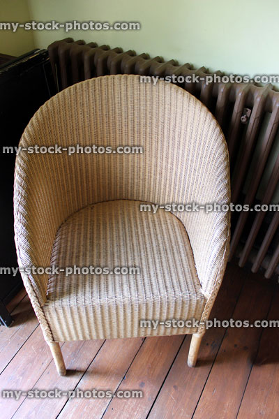 Stock image of hand woven wicker rattan loom style chair for bedroom / conservatory, honey coloured