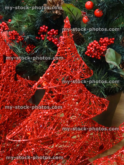 Stock image of wicker Christmas trees / decorations, painted with sparkling red glitter paint