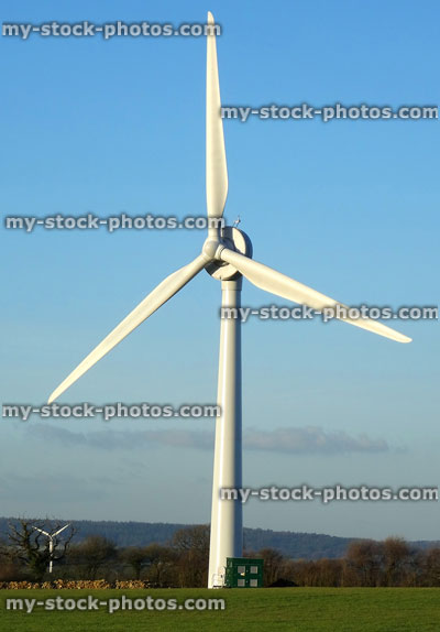 Stock image of wind farm turbine generator, windmill generating renewable energy