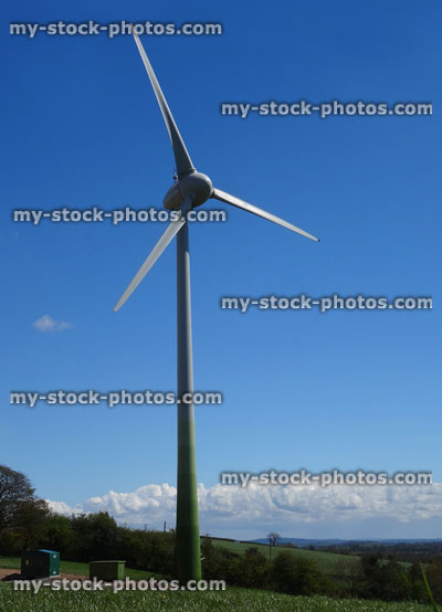 Stock image of tall modern wind turbine windmill in countryside field