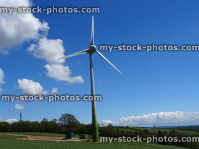 Stock image of wind turbine windmill in countryside farm field, generating electricity