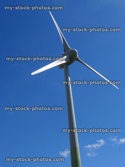 Stock image of three sail blades on windmill wind turbine, blue sky