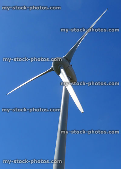 Stock image of wind turbine sails, windmill isolated with blue sky background