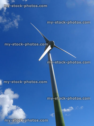 Stock image of wind farm windmill turbine isolated against blue sky