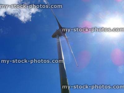 Stock image of windmill tower with wind turbine converting kinetic energy