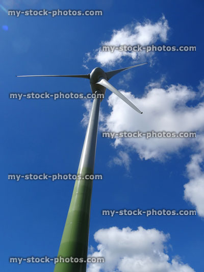 Stock image of green wind turbine windmill generating electricity / kinetic energy