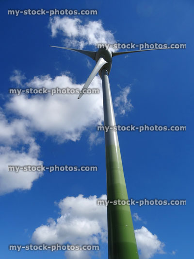 Stock image of wind turbine pictured from low angle, windmill generator