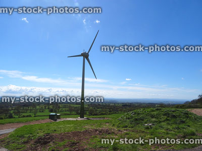 Stock image of wind turbine windmill with three sails, renewable energy