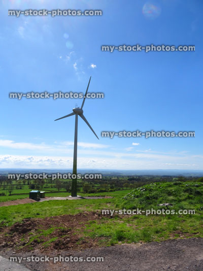 Stock image of distant wind turbine with windmill sails, environmentally friendly
