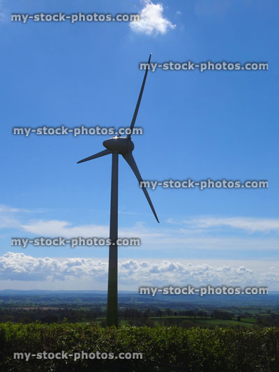 Stock image of wind turbine windmill isolated against blue sky