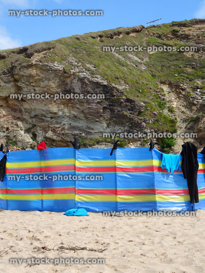 Stock image of seaside windbreak on beach, striped with wooden poles