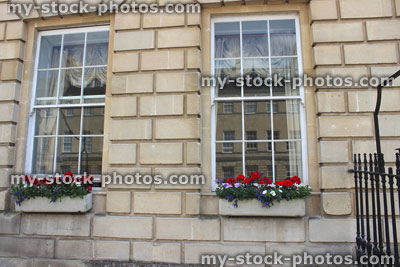 Stock image of window boxes with red Geranium flowers (pelargoniums) on Georgian house