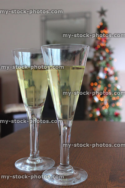 Stock image of glasses of white wine with Christmas tree fairy lights