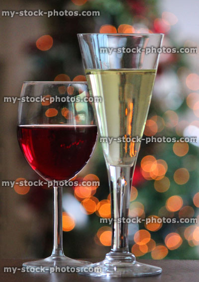 Stock image of red and white wine glasses, blurred Christmas fairylights
