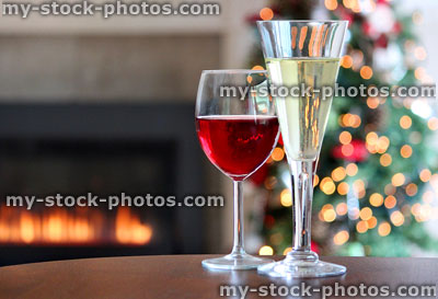 Stock image of red and white wine glasses, gas fire, Christmas tree fairylights