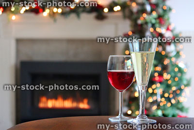 Stock image of red wine / flute glass, gas fire, garland, Christmas tree fairylights