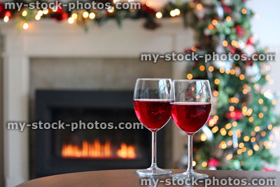 Stock image of red wine glasses, gas fire / fireplace, Christmas decorations