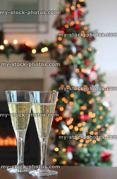Stock image of Christmas tree decorations, flute glasses with sparkling white wine