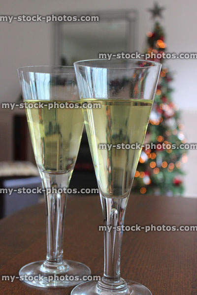 Stock image of two glasses of white wine with blurred Christmas tree
