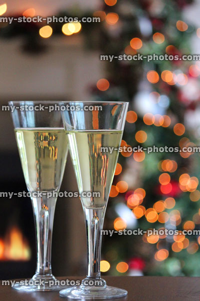 Stock image of white wine glasses with Christmas tree fairy lights