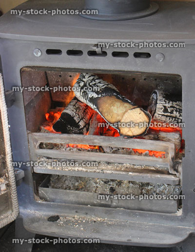 Stock image of multi fuel woodburner stove fireplace, fire burning logs / wood flames