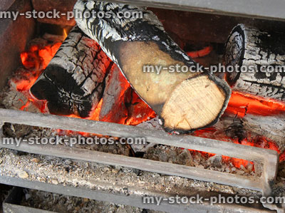 Stock image of fireplace grate with burning logs / wood, woodburner stove