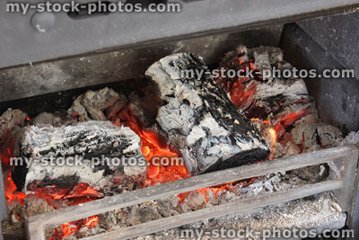 Stock image of logs burning in wood burner stove, fire grate