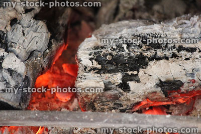 Stock image of open fire, burning wood logs, ash, red hot embers