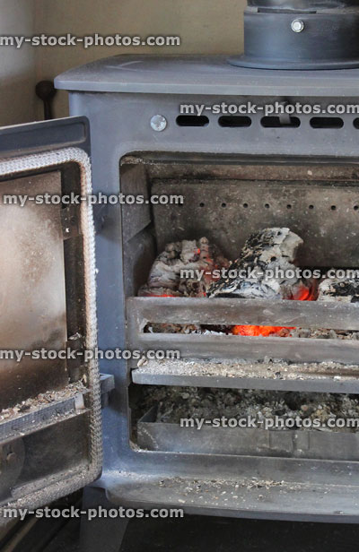 Stock image of cast iron wood burning stove with fire / flames, logs
