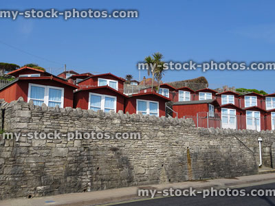 Stock image of traditional wooden beach huts / summer houses by road