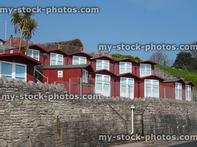 Stock image of wooden beach huts / sheds with white double doors
