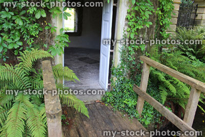 Stock image of small wooden bridge with handrails, stream / river
