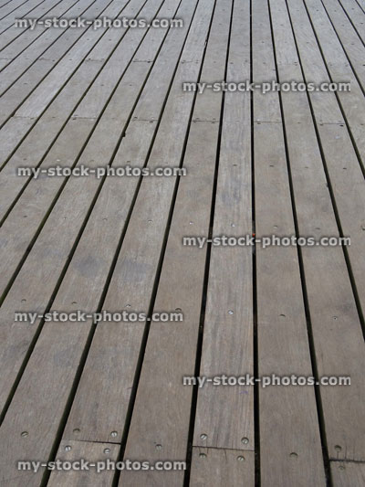 Stock image of smooth teak decking timber lengths, weathered hardwood decking