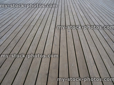 Stock image of smooth teak decking timber lengths, weathered hardwood decking