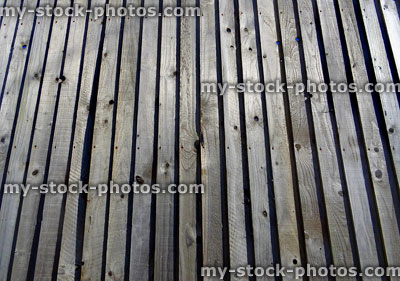 Stock image of wooden featherboard fence, wood featheredge fencing panels / timber