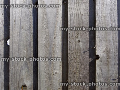 Stock image of wooden featherboard fence, timber board fencing panels, feather edge