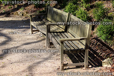 Stock image of two wooden benches / seats, teak hardwood garden furniture