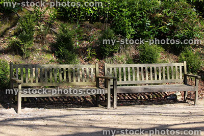 Stock image of long wooden benches / hardwood teak garden seats / furniture