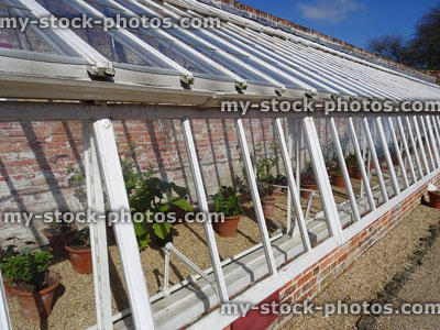 Stock image of garden greenhouse / glasshouse / hothouse, wooden frame, glass windows