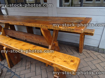 Stock image of varnished wood table and bench, outdoor garden furniture