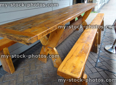 Stock image of varnished wood table and bench, outdoor garden furniture