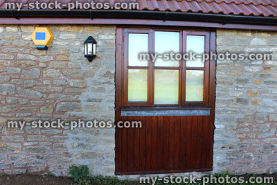 Stock image of old barn conversion house / bungalow, converted stable door, wooden window