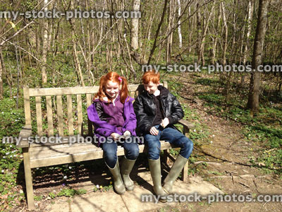 Stock image of children sat on a woodland bench