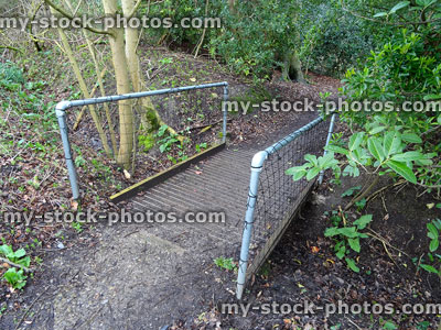 Stock image of metal bridge with non slip decking covered in chicken wire