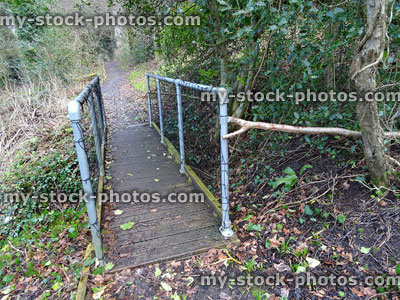 Stock image of small bridge in woodland garden, decking with chicken wire