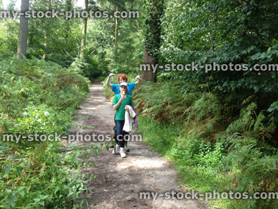 Stock image of young children walking along a woodland pathway