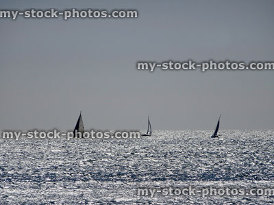 Stock image of small yachts sailing on choppy sea in distance